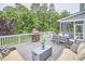 Spacious back deck with dining area, grill, lounge area, and views of a lush backyard at 112 Filigree Way, Durham, NC 27713