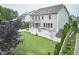 Back of home with a large deck, screened porch, and green lawn at 112 Filigree Way, Durham, NC 27713