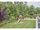Expansive backyard with lush lawn, playground, and wooded views offer an outdoor retreat at 112 Filigree Way, Durham, NC 27713