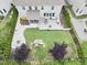Aerial view of a backyard featuring a fire pit, play set, and manicured lawn at 112 Filigree Way, Durham, NC 27713