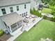 Expansive backyard featuring a screened porch, deck, patio furniture, grill, and well-maintained lawn at 112 Filigree Way, Durham, NC 27713