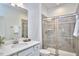 Bathroom with a marble countertop, chrome fixtures, and a tiled walk-in shower at 112 Filigree Way, Durham, NC 27713