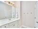 Bright bathroom features a white vanity with a large mirror and modern lighting at 112 Filigree Way, Durham, NC 27713