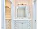 Bright bathroom boasts a white vanity with ample storage and modern fixtures near closet at 112 Filigree Way, Durham, NC 27713
