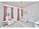 Bedroom with a crib, rocking chair, and decorative chandelier at 112 Filigree Way, Durham, NC 27713