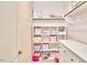 Walk-in closet features custom shelving, ample storage space, and pink accent wall at 112 Filigree Way, Durham, NC 27713