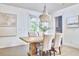 Elegant dining room with a rustic wood table and an eye-catching chandelier at 112 Filigree Way, Durham, NC 27713