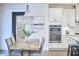 Dining area showcasing stylish chandelier, rustic table, and open view of the kitchen at 112 Filigree Way, Durham, NC 27713