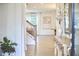 Elegant entryway with hardwood floors, staircase, and views into the adjacent living spaces filled with natural light at 112 Filigree Way, Durham, NC 27713