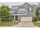 Beautiful two-story home with brick and siding, an attached two car garage, and a meticulously manicured front lawn at 112 Filigree Way, Durham, NC 27713