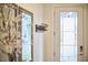 Foyer features a coat rack, mirror, and a white front door with decorative glass at 112 Filigree Way, Durham, NC 27713