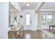 Bright foyer with hardwood floors, decorative mirror, and a view into the adjoining room at 112 Filigree Way, Durham, NC 27713