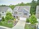 Beautiful two-story home featuring a landscaped yard, gray brick, and two-car garage at 112 Filigree Way, Durham, NC 27713