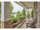 Cozy covered front porch with a bench, manicured landscaping, and a view of the neighborhood at 112 Filigree Way, Durham, NC 27713