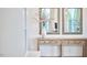 Hallway with a rustic wood table, floral arrangement, decorative mirrors, and electrical outlet at 112 Filigree Way, Durham, NC 27713