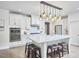 Bright kitchen featuring white cabinets, stainless steel appliances, an island, and stylish pendant lighting at 112 Filigree Way, Durham, NC 27713