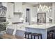 Bright kitchen features white cabinets, stainless steel appliances, and an island with seating at 112 Filigree Way, Durham, NC 27713