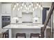 Kitchen featuring white cabinets, stainless steel appliances, granite counters, and bar seating at 112 Filigree Way, Durham, NC 27713