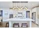 Modern kitchen with white cabinets, stainless steel appliances, an island, and pendant lighting at 112 Filigree Way, Durham, NC 27713