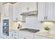 Well-equipped kitchen with stainless steel appliances, white cabinets, and a stylish backsplash at 112 Filigree Way, Durham, NC 27713