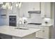 Bright kitchen with stainless steel appliances, white cabinets, and a granite island at 112 Filigree Way, Durham, NC 27713