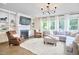 Cozy living room featuring a fireplace, built-in shelves, and plenty of natural light at 112 Filigree Way, Durham, NC 27713