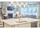Living room with a fireplace, custom built-ins, and island countertop overlooking the dining area at 112 Filigree Way, Durham, NC 27713