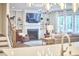 Living room featuring a fireplace, custom built-ins, and large windows at 112 Filigree Way, Durham, NC 27713