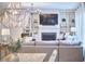 Open-concept living room with a fireplace, built-in shelving, and comfortable seating at 112 Filigree Way, Durham, NC 27713