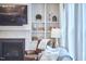 Comfortable living room features a cozy fireplace, custom built-ins, and a luxurious leather chair at 112 Filigree Way, Durham, NC 27713