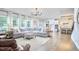 Bright living room with large windows, hardwood floors, and a comfortable sectional sofa at 112 Filigree Way, Durham, NC 27713