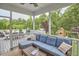 Relaxing screened porch with a comfortable sectional sofa, coffee table, and outdoor dining at 112 Filigree Way, Durham, NC 27713
