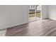 Living room showcasing wood-look flooring and natural light from the sliding glass door at 1201 Solace Way, Rolesville, NC 27571