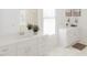 Bright bathroom featuring dual vanities, white cabinets, and neutral tile flooring at 1207 Masters Place Way # 184, Durham, NC 27703