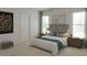 Comfortable bedroom featuring soft carpet, neutral walls, and two windows for natural light at 1207 Masters Place Way # 184, Durham, NC 27703