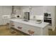 Modern white kitchen with a large center island, stainless steel appliances and three bar stools at 1207 Masters Place Way # 184, Durham, NC 27703