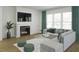 Bright living room with a fireplace, large windows, and comfortable gray seating area at 1207 Masters Place Way # 184, Durham, NC 27703