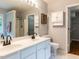 Bright bathroom features dual sinks, walk-in shower, and a linen closet at 122 Button Rd, Morrisville, NC 27560