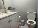 Updated bathroom features white cabinets, a marble countertop, modern sink, and fixtures at 122 Button Rd, Morrisville, NC 27560