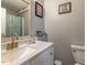 Updated bathroom with a granite countertop sink, modern faucet, and decorative mirror and a bathtub with shower at 122 Button Rd, Morrisville, NC 27560