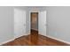 Bedroom featuring hardwood floors, doors, and neutral gray walls at 122 Button Rd, Morrisville, NC 27560