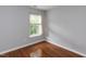 Bedroom with hardwood floors, a window, and neutral gray walls at 122 Button Rd, Morrisville, NC 27560