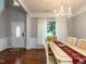 Formal dining area boasts an elegant chandelier and plenty of natural light at 122 Button Rd, Morrisville, NC 27560