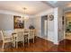Elegant dining room featuring hardwood floors, a chandelier, and traditional decor with a large painting at 122 Button Rd, Morrisville, NC 27560
