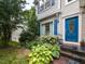 Close-up of a house with a blue front door and manicured landscaping around the entrance at 122 Button Rd, Morrisville, NC 27560