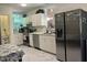 Bright kitchen with white cabinets, stainless steel appliances, and a view to a staircase at 122 Button Rd, Morrisville, NC 27560