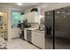 Charming kitchen features white cabinets, stainless appliances and sink and a window overlooking the exterior at 122 Button Rd, Morrisville, NC 27560