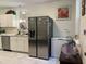 Kitchen features stainless steel refrigerator and freezer, white cabinets, modern appliances, and decor at 122 Button Rd, Morrisville, NC 27560