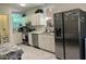 Bright kitchen features white cabinetry, stainless steel appliances, marble-look floors, and lots of natural light at 122 Button Rd, Morrisville, NC 27560