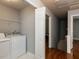 Laundry area with washer, dryer, shelving, and access to the rest of the house at 122 Button Rd, Morrisville, NC 27560
